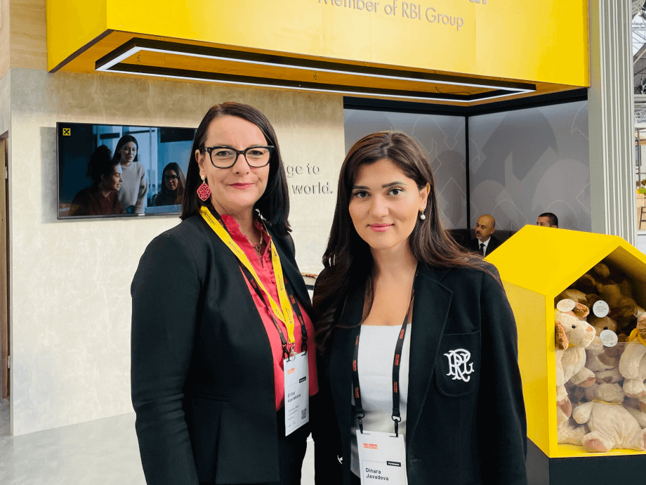 Sibos Awards photo - Two RBI Colleagues in front of the yelllow RBI section