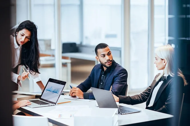 A group of people sitting in a conference room