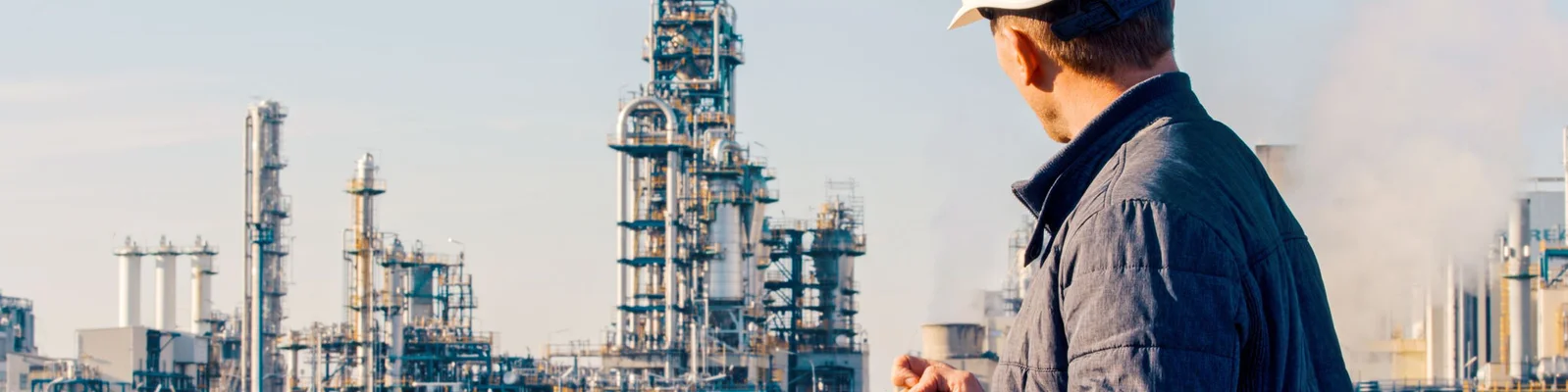 Factory Worker looking at factory - 1