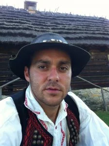 Slovakian traditional costume, with classical black hat, white shirt and a traditional red and black gilette.