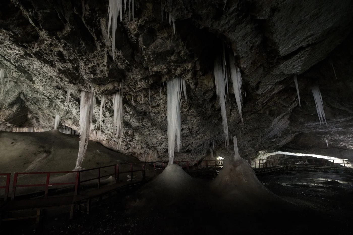 Underground glacier in Glaciers Cave in Apuseni mountains, Scarisoara, Romania. Big icicles holding on ceiling in the cave