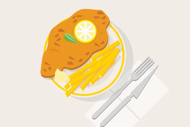 Eine köstliche Portion knuspriges Schnitzel mit goldenen Pommes frites, garniert mit einer Zitronenscheibe – servierfertig.