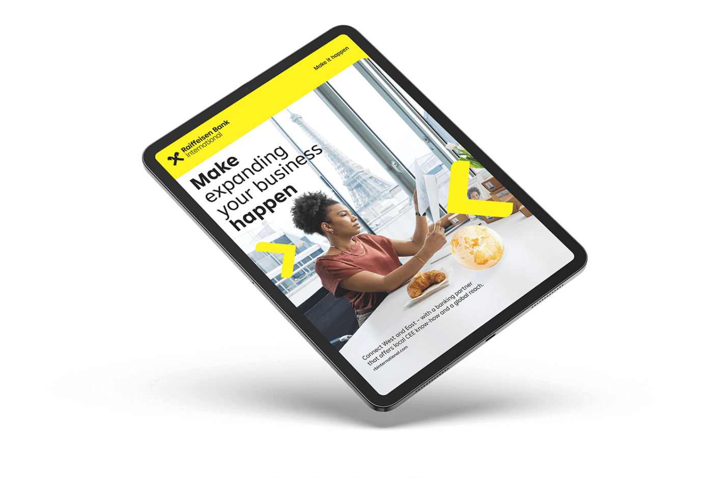 A tablet showing a promotional page with a woman working at a desk, the Eiffel Tower in the background, and branding elements of Raiffeisen Bank.