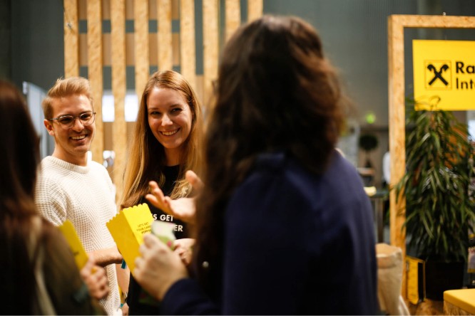 Two people smiling at a networking event