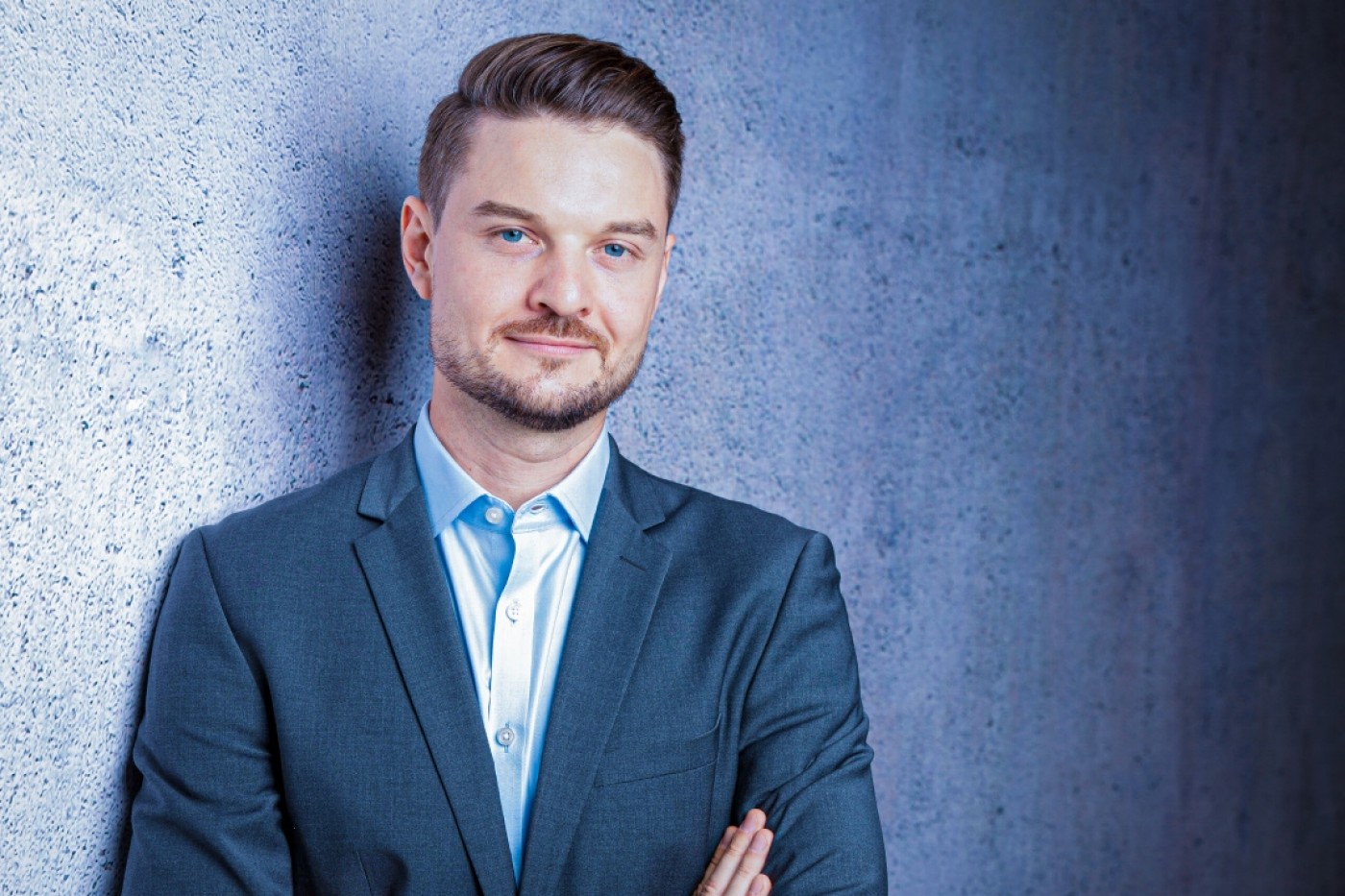 Portrait of a young male business professional in a modern office environment, showcasing emerging leadership in finance