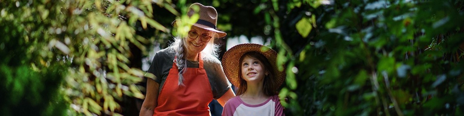older woman and girl in a garden