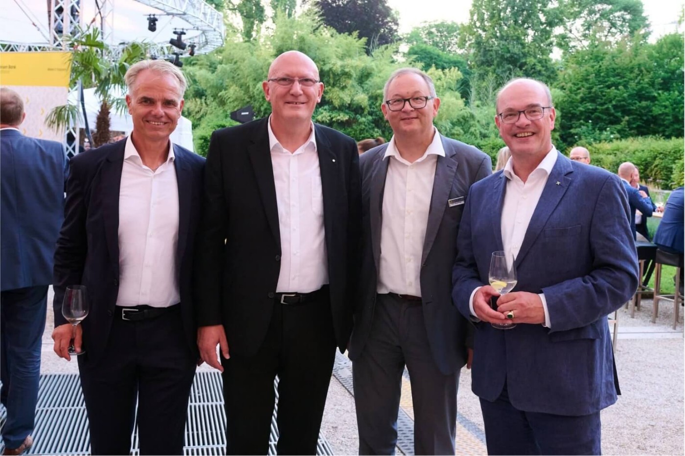 four smiling business men