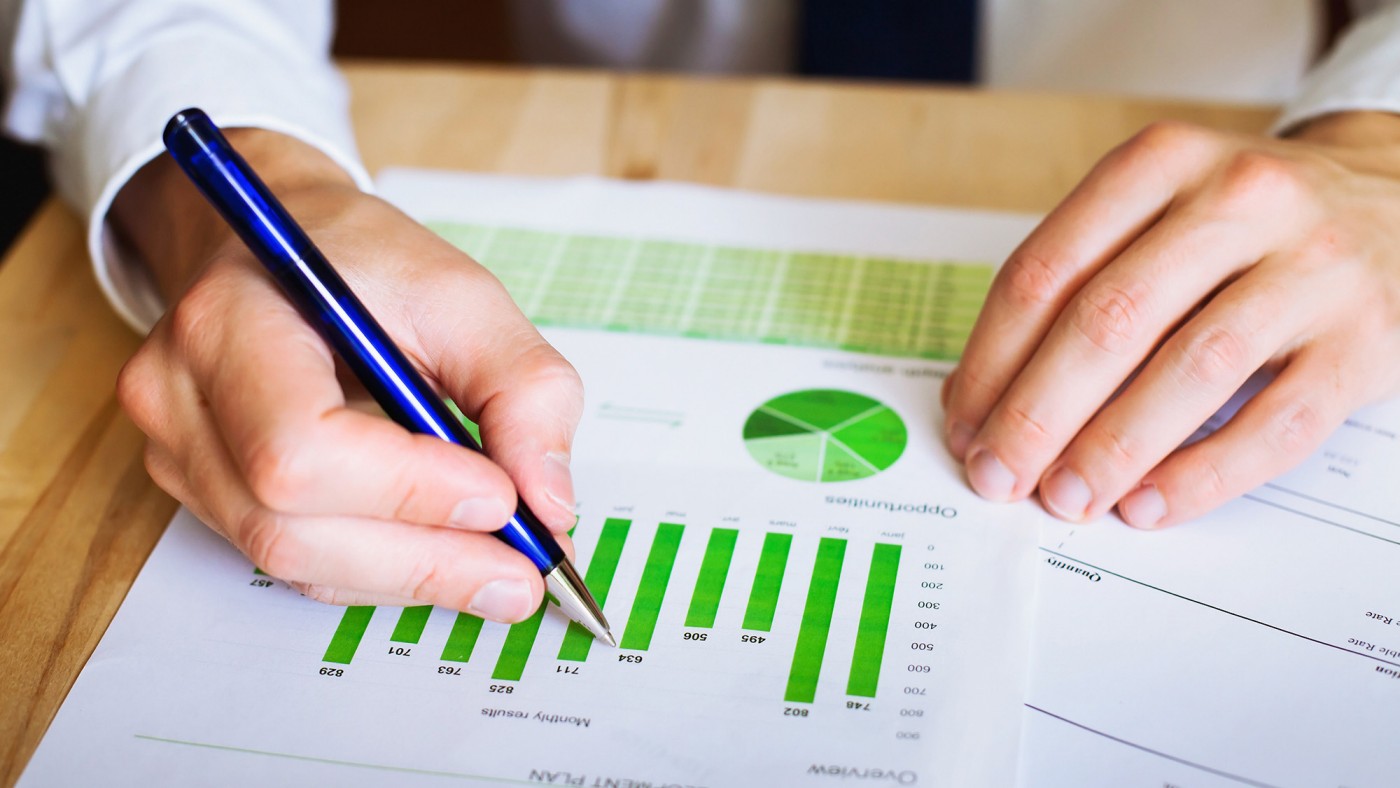 man writing on paper with diagrams