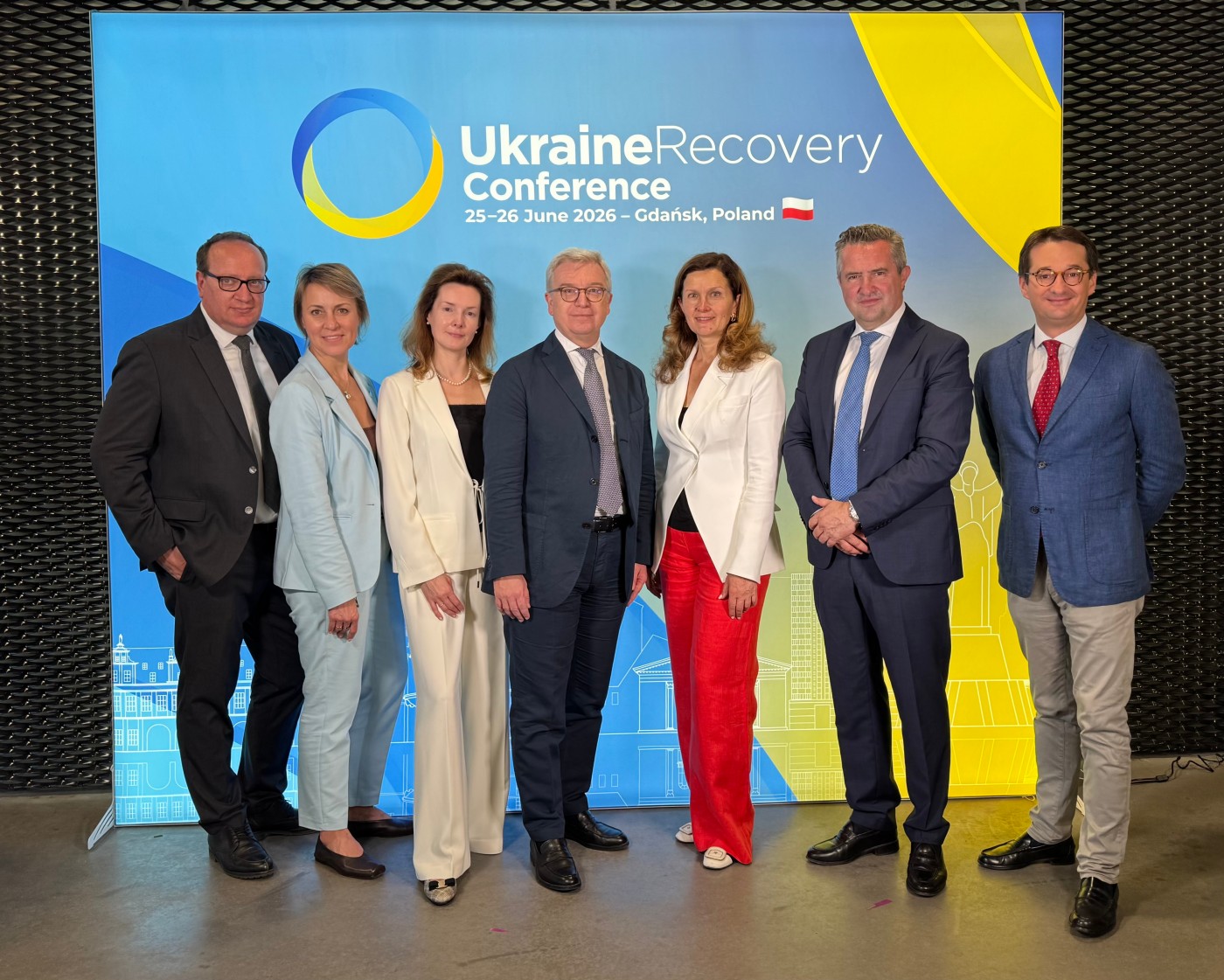 Group of people in front of a URC photo wall