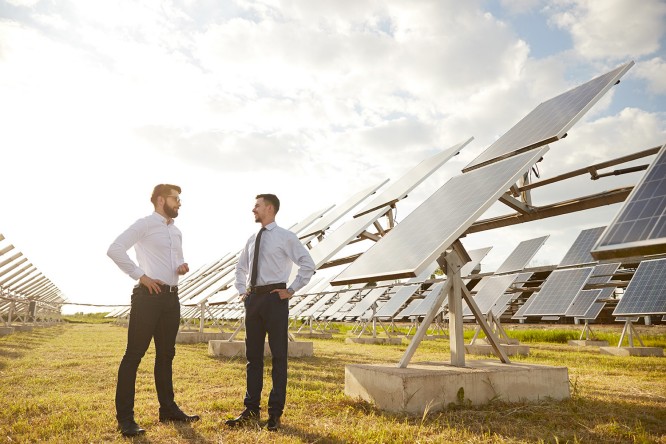 ESG | two business man standing in front of solar energy